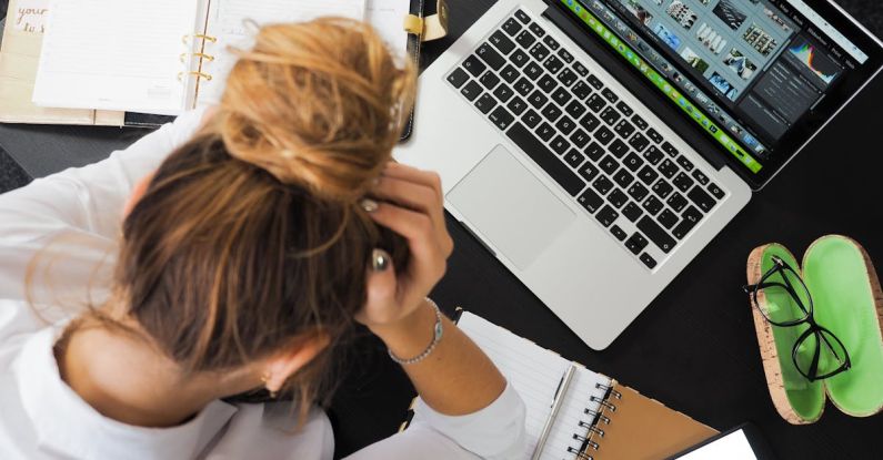 Work Stress - Woman Sitting in Front of Macbook