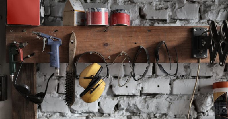 Toolkit - Various instruments hanging on wooden board in garage