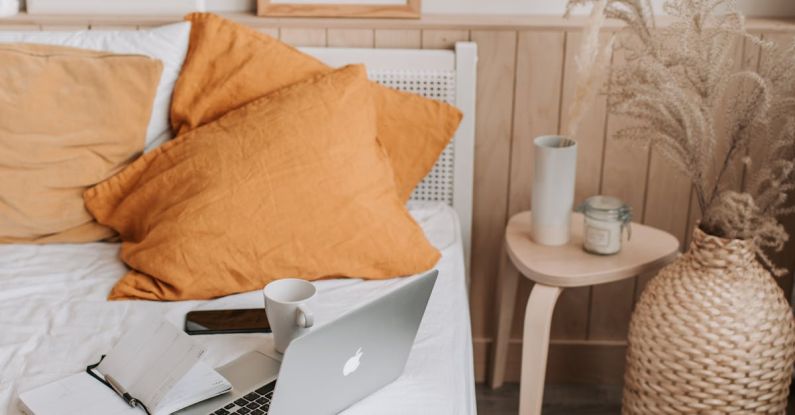 Painting Furniture - Empty bed with laptop and notebook
