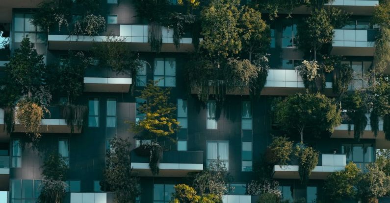 Small Apartment - Modern residential building facade decorated with green plants