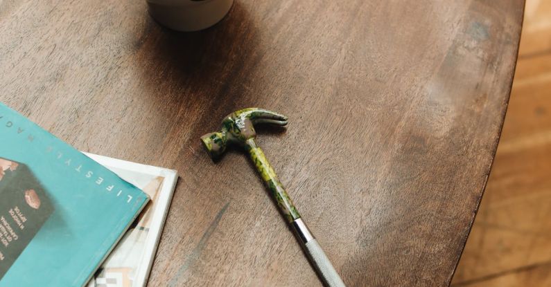 Home Repairs - Hammer Lying on Wooden Table