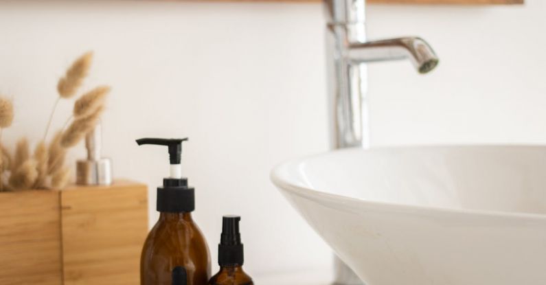 Leaky Faucet - Sink with skincare products in bathroom