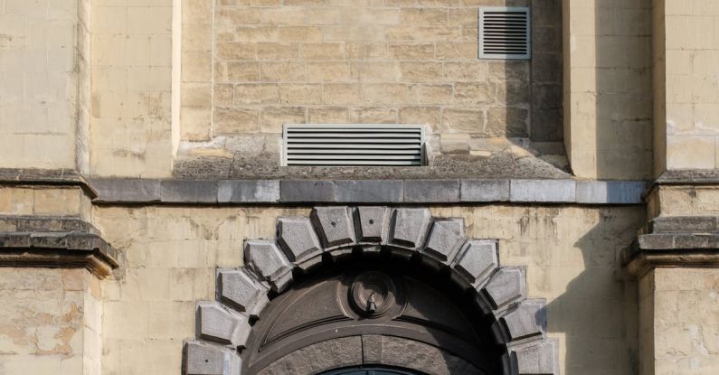 Squeaky Door - A blue door is in front of a building