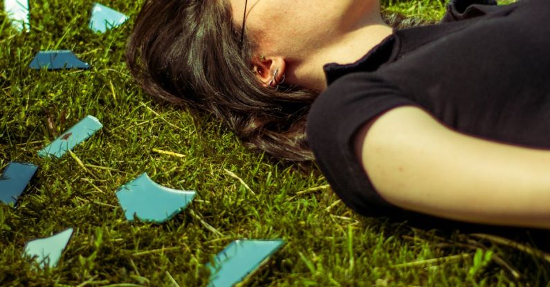 Cracked Mirror - Woman Lying Down with Mirror and Cracked Glass around