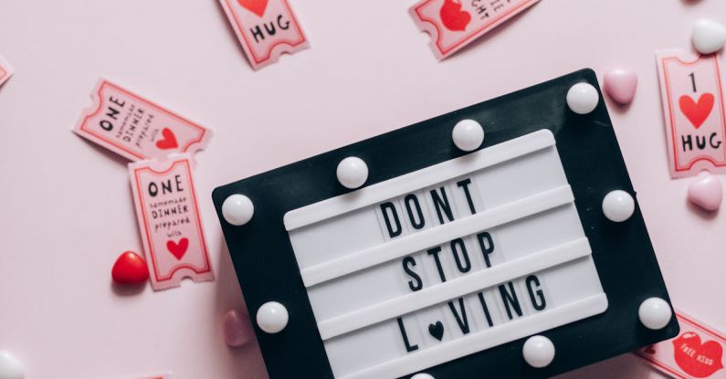 Coupons - Flat Lay of Don't Stop Loving Sign Surrounded by Movie Coupons